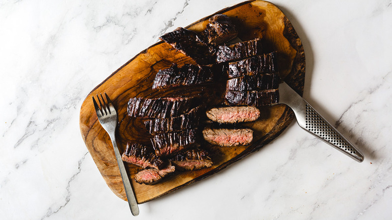 Sliced steak on cutting board