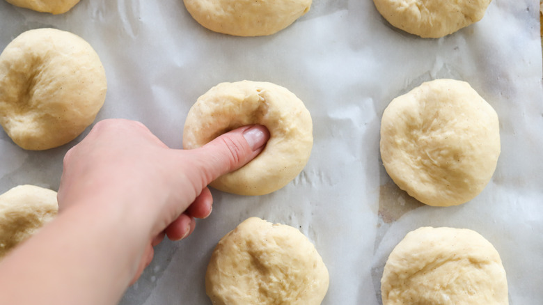 finger pressing into dough ball