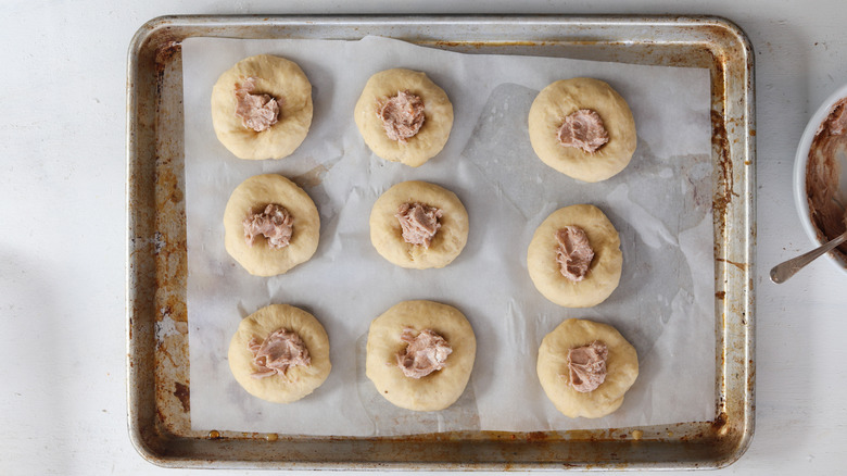 cream cheese filling on a dough ball