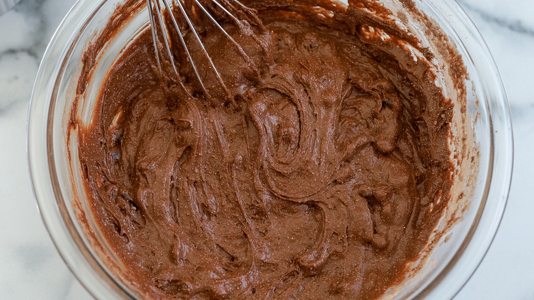 chocolate cake mix in bowl with whisk