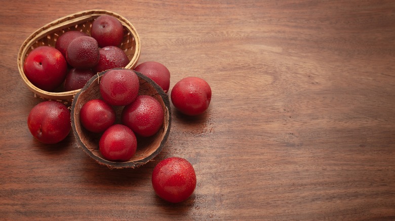 Wooden bowls of cherry plums