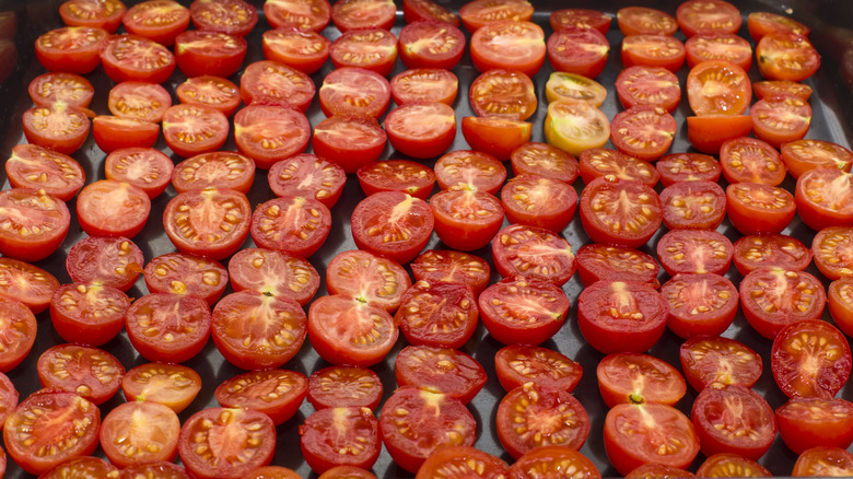 cherry tomato halves on baking sheet