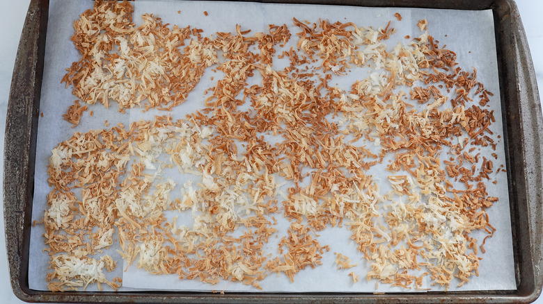 baked shredded coconut on a sheet pan