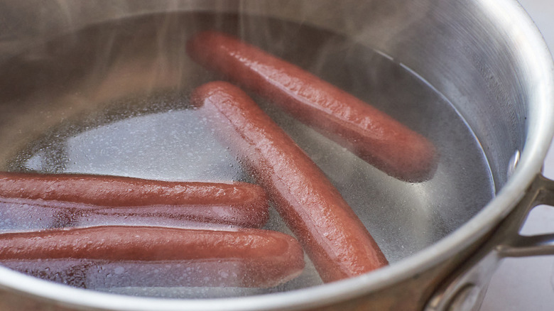 hot dogs boiling in pot