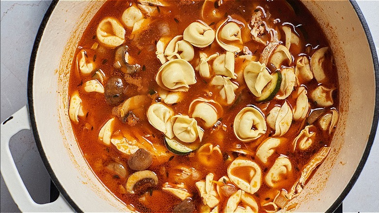 tortellini cooking in broth