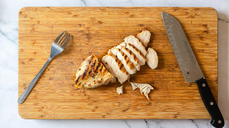 Sliced chicken on cutting board