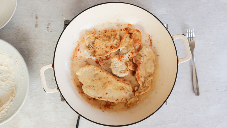 chicken cutlets frying in pan