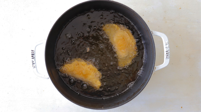 empanadas frying in oil