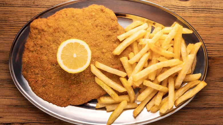 Chicken milanese plated with fries