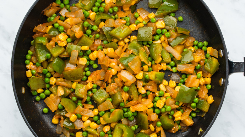 assorted vegetables cooking in pan
