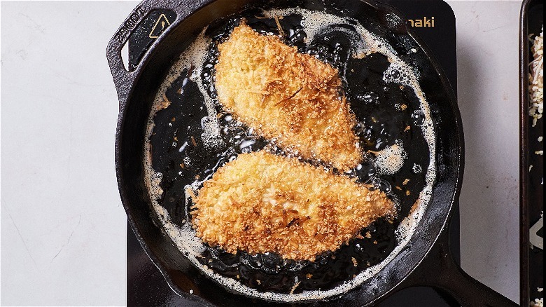 frying chicken cutlet in skillet