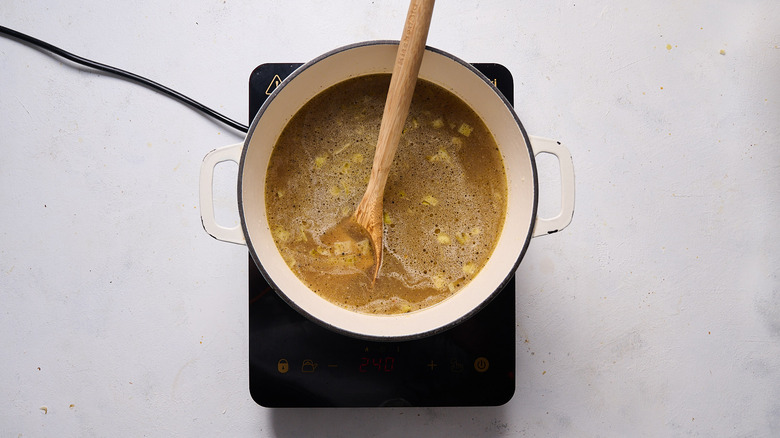 broth and parmesan in pot