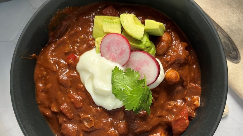 bowl of chili with toppings, close up