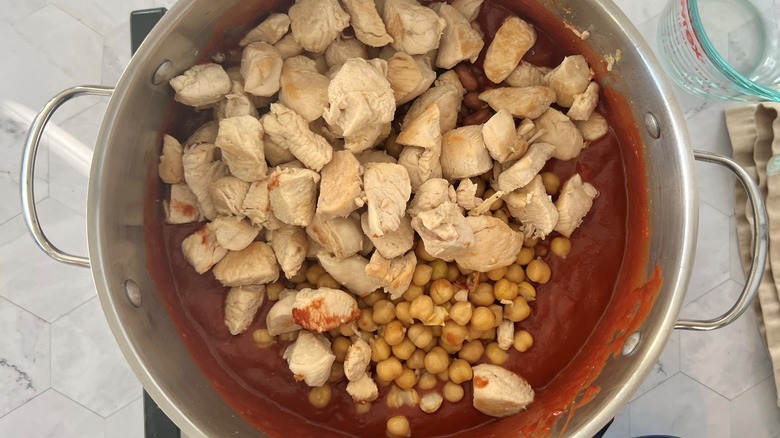 chicken and beans in pot of tomato sauce