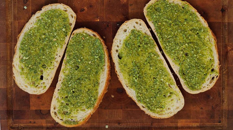 Four slices of bread with pesto