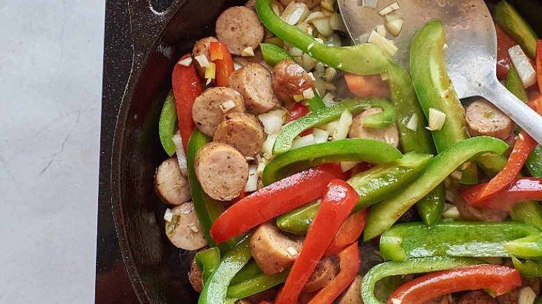 cooking sausage and pepper in skillet