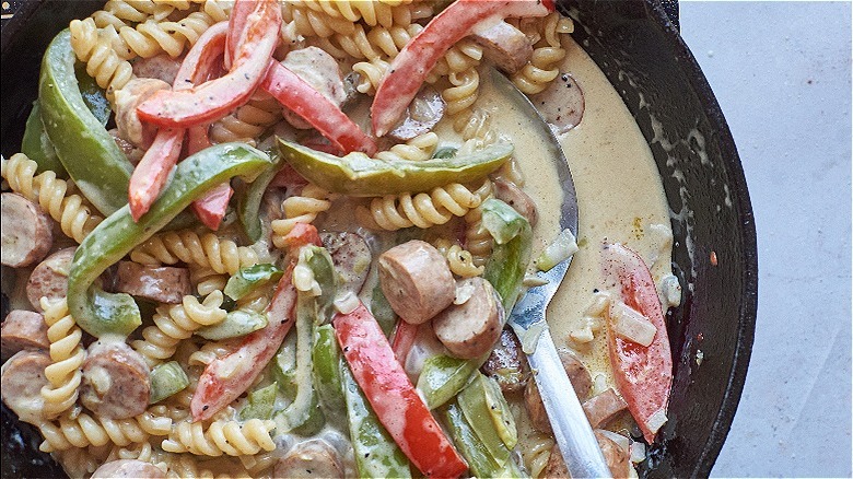 spoon scooping peppers and pasta