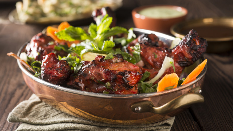 large metal bowl of chicken tandoori