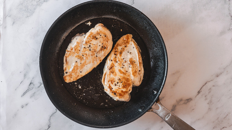 Seared chicken breasts in pan