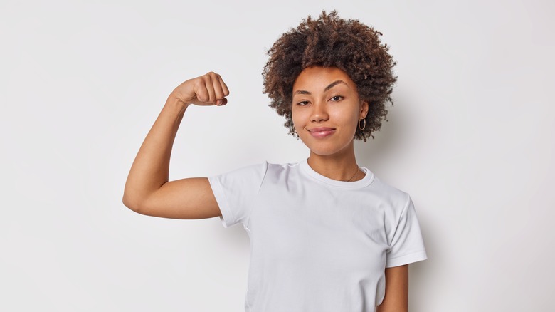 woman flexes her arm