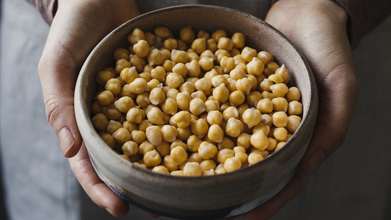 woman holding bowl of chickpeas