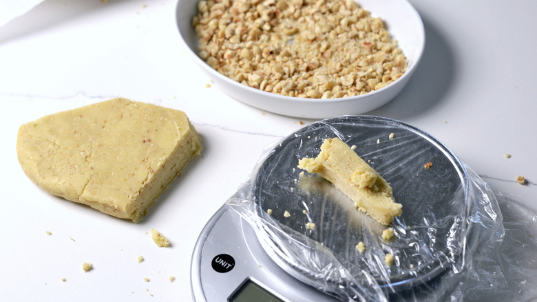 Weighing out portions of dough for hazelnut thumbprint cookie recipe