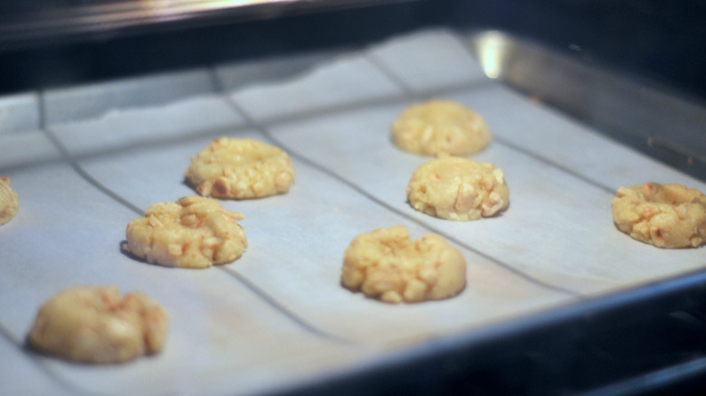 Hazelnut thumbprint cookies baking in an oven