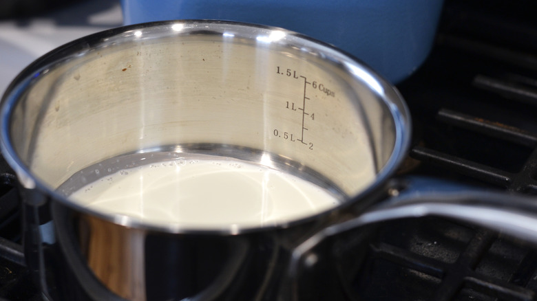 Heavy cream being heated in a pan