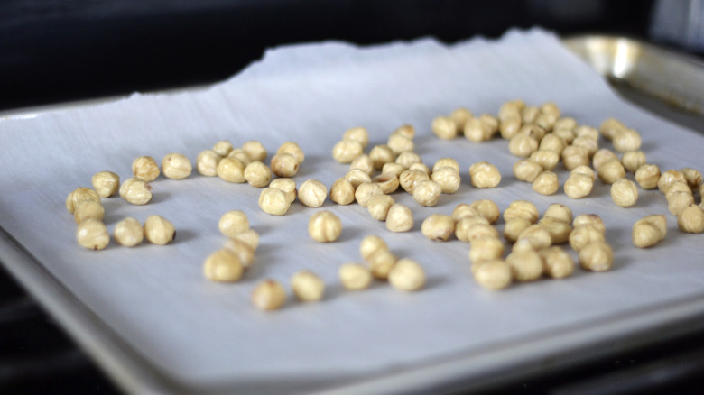 Hazelnuts on a lined baking sheet