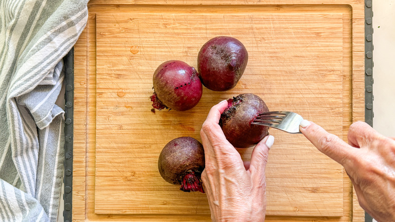 hand piercing beet