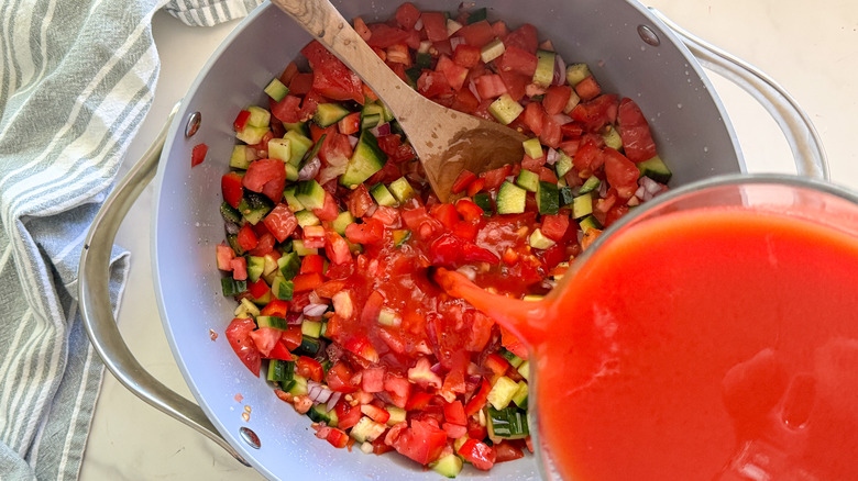 pouring tomato sauce in soup