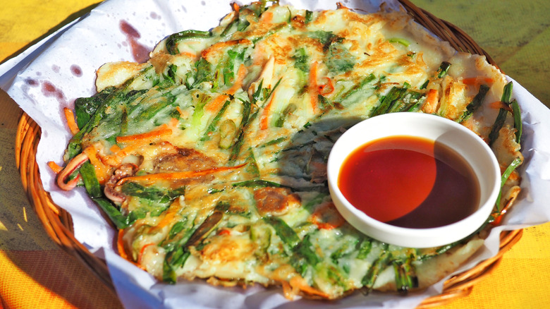 Seafood pajeon in a basket with dipping sauce