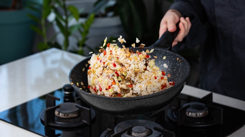 Home cook flipping fried rice