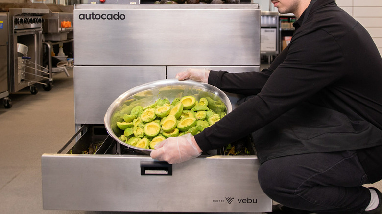 employee using Chipotle autocado avocado machine