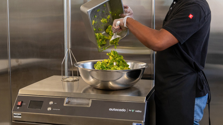 person loading chipotle autocado robot