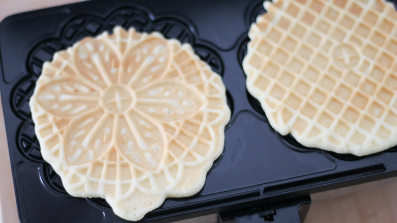 cooked pizzelles in pizzelle maker