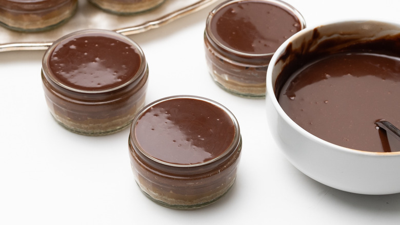 topping cheesecake pots with ganache