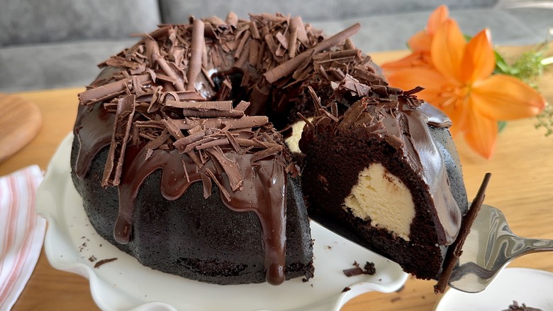 Serving slice of chocolate cream cheese bundt