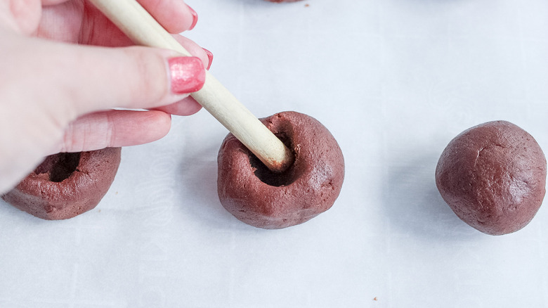 wooden stick pressing into cookie dough