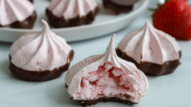 close up of a bitten into chocolate strawberry meringue cookies