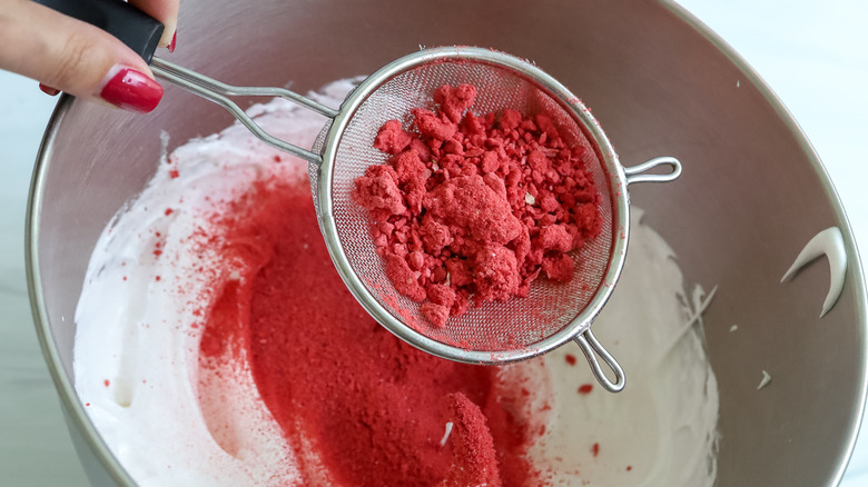 strawberry powder being sifted into a bowl