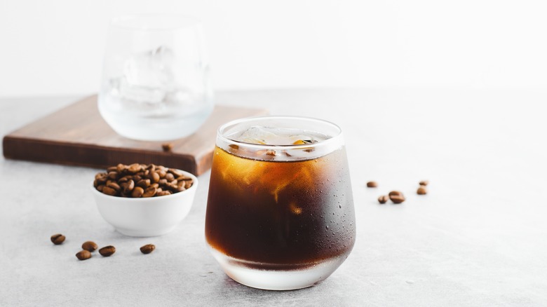 Cold brew coffee and cup of coffee beans