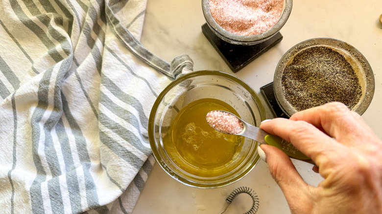 adding salt to bowl