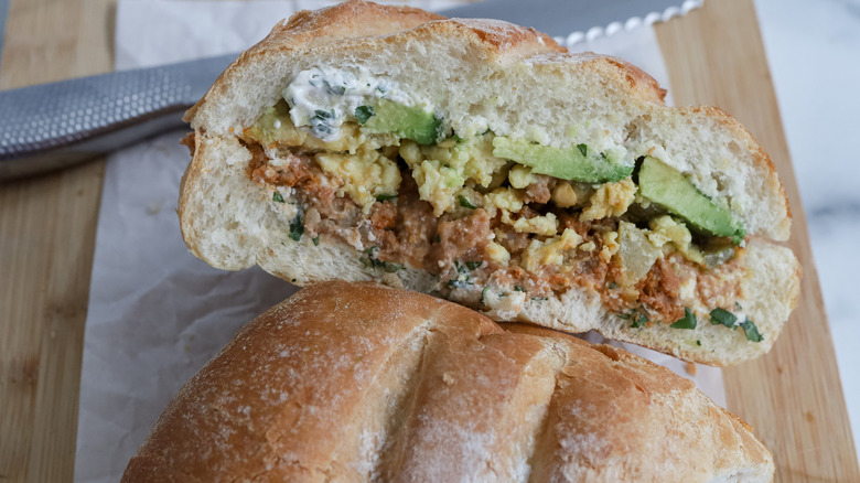 a sliced torta on a cutting board with a knife