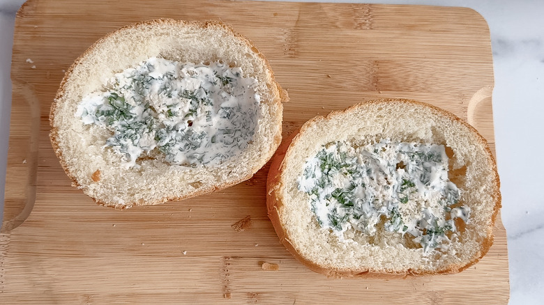 top and bottom of a telera roll spread with cilantro crema