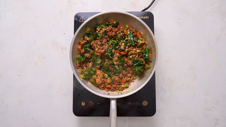 wilting kale in skillet