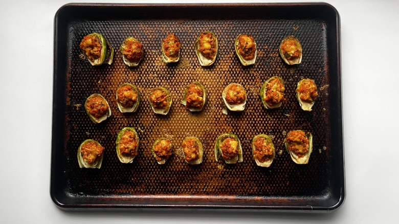 baked chorizo-stuffed brussels sprouts on a baking sheet