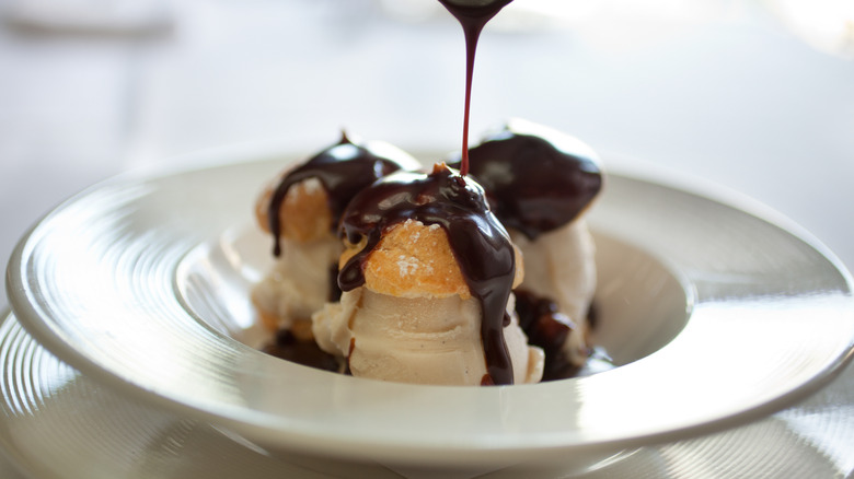 Profiteroles with ice cream and chocolate sauce