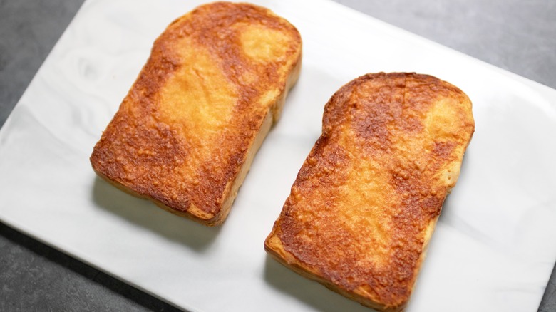 paremsan crusted bread on a white plate