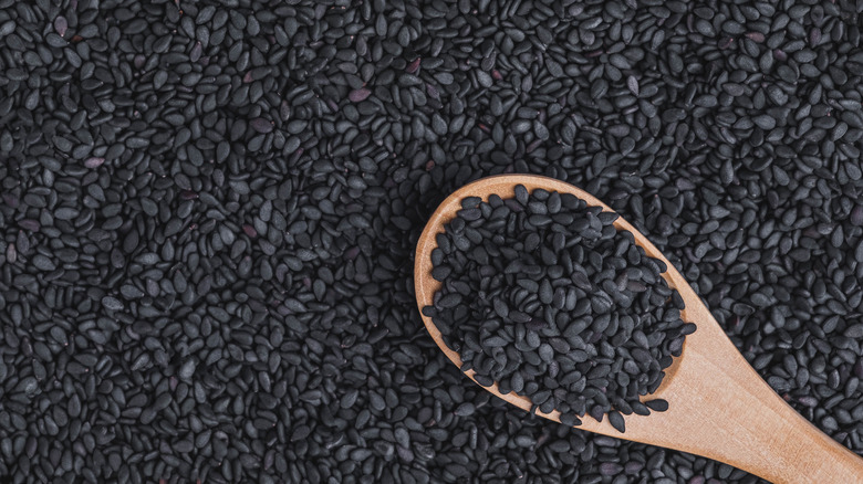 Black sesame seeds with wooden spoon